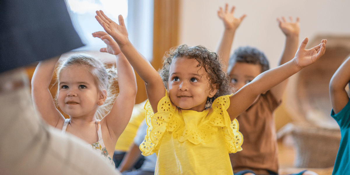Group of preschool children waving their arms