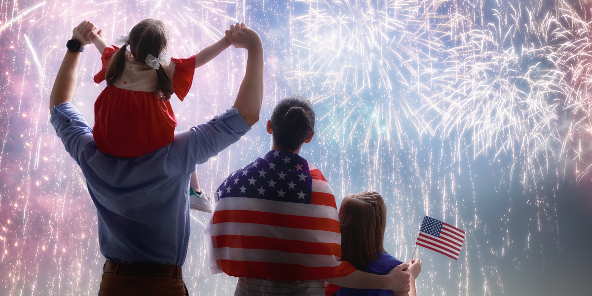 Family of four viewing red, white, and blue fireworks